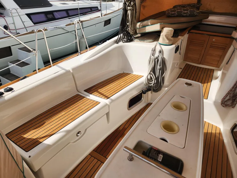 Slide: The Image of Beneteau Oceanis 50 cockpit, 2012 model, featuring teak seating and deck, with mooring ropes. - 15