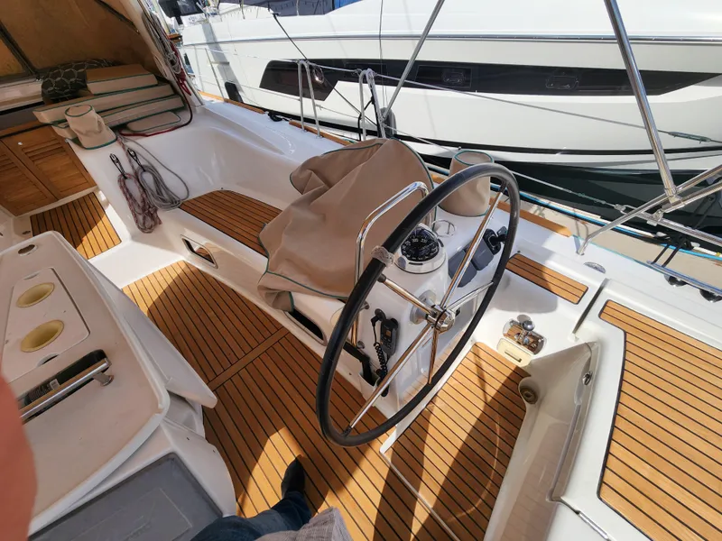 Slide: The Image of Cockpit of 2012 Beneteau Oceanis 50 sailboat with teak flooring and steering wheel. - 22