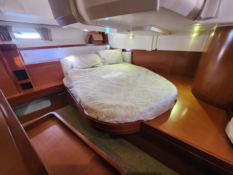 Slide: The Image of Luxurious cabin interior of 2012 Beneteau Oceanis 50 yacht with cozy bed and wooden finish. - 23