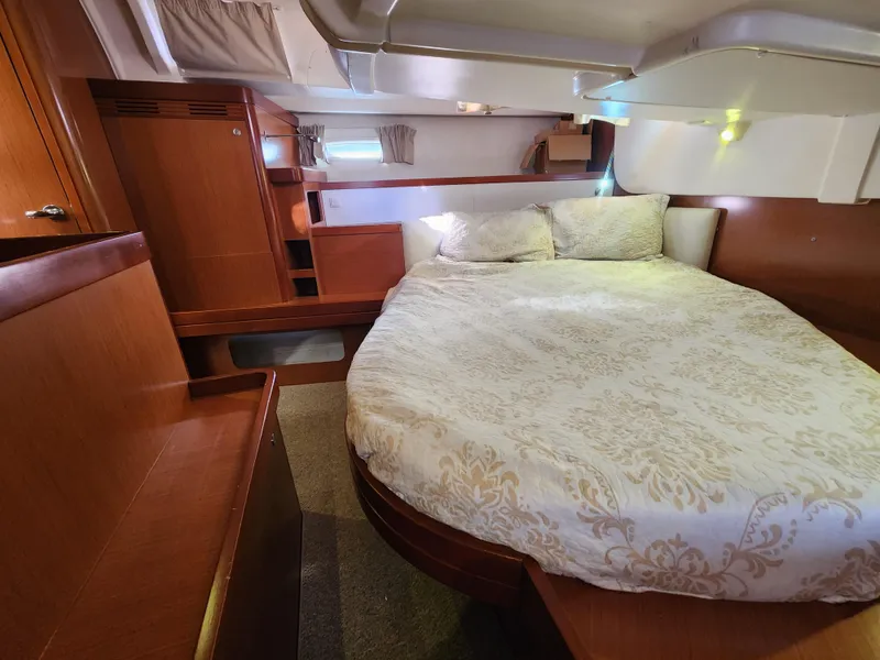 Slide: The Image of Luxurious cabin interior of 2012 Beneteau Oceanis 50 yacht with cozy bed and wooden furnishings. - 24