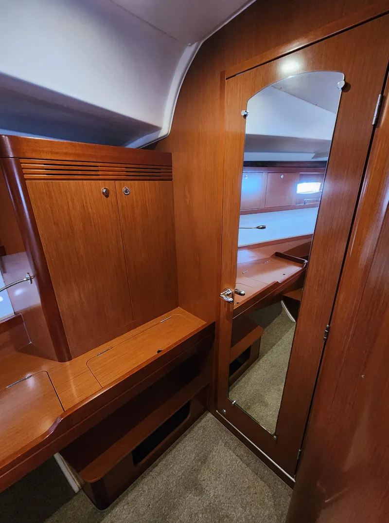 Slide: The Image of Interior of 2012 Beneteau Oceanis 50 yacht with wooden cabinetry and mirrored door. - 28