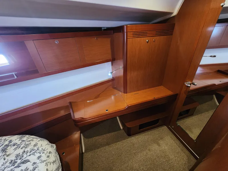 Slide: The Image of 2012 Beneteau Oceanis 50 interior with wooden cabinetry and mirror, showcasing elegant yacht design. - 29