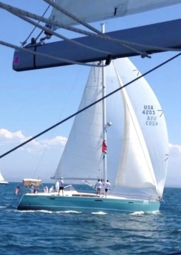 Slide: The Image of 2012 Beneteau Oceanis 50 sailing yacht on open water, full sails, clear sky. - 3