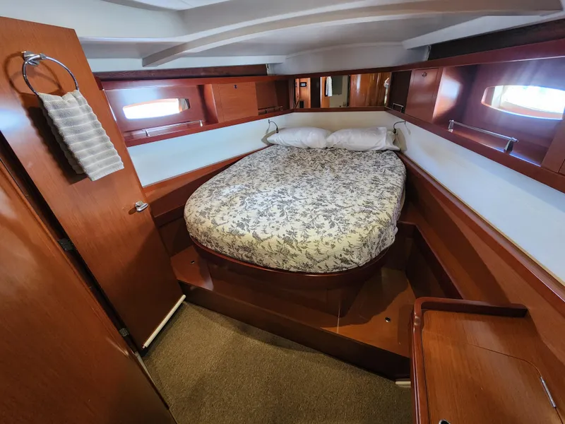 Slide: The Image of Luxurious cabin interior of 2012 Beneteau Oceanis 50 yacht with cozy bed and wooden finish. - 30