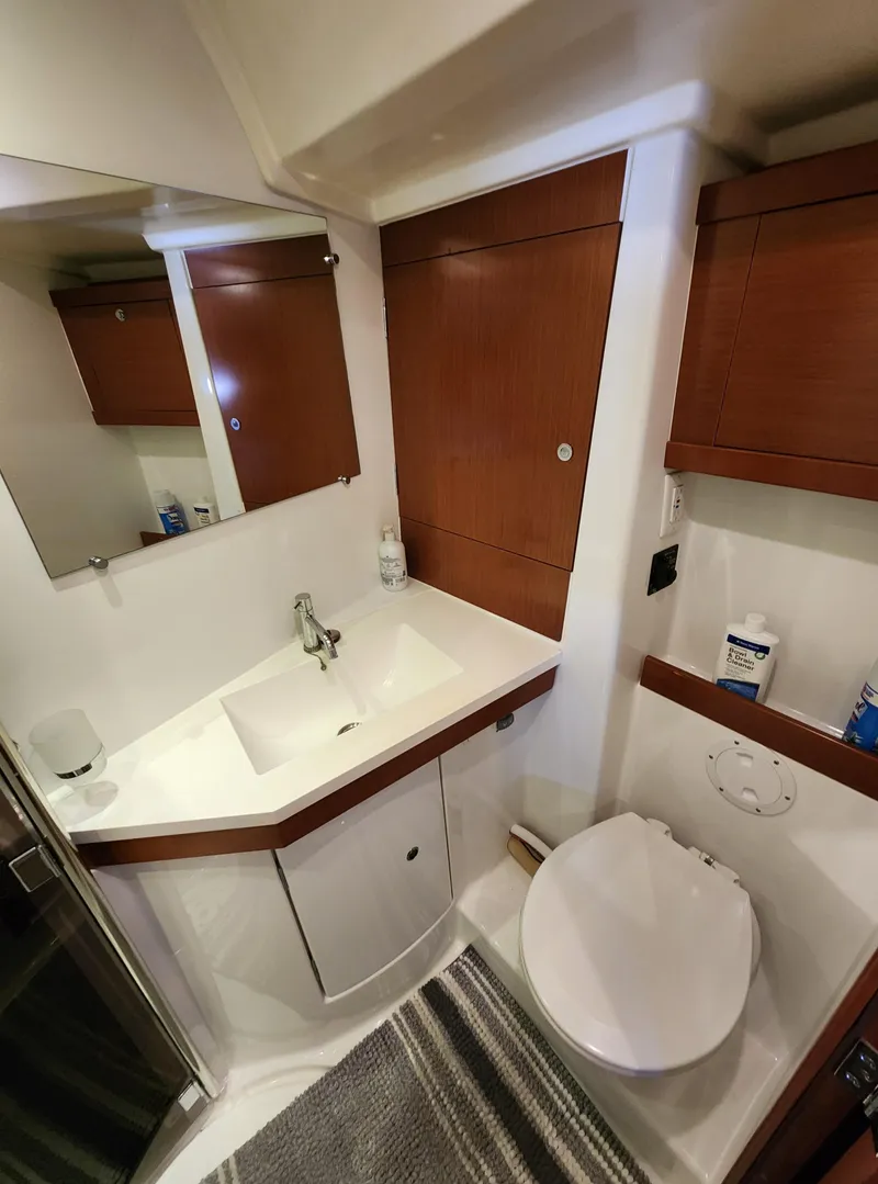 Slide: The Image of Bathroom interior of 2012 Beneteau Oceanis 50 yacht with modern fixtures and wood accents. - 32