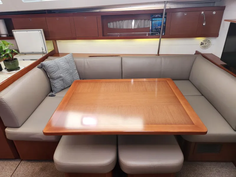 Slide: The Image of Interior of 2012 Beneteau Oceanis 50 yacht with elegant dining area and cushioned seating. - 45