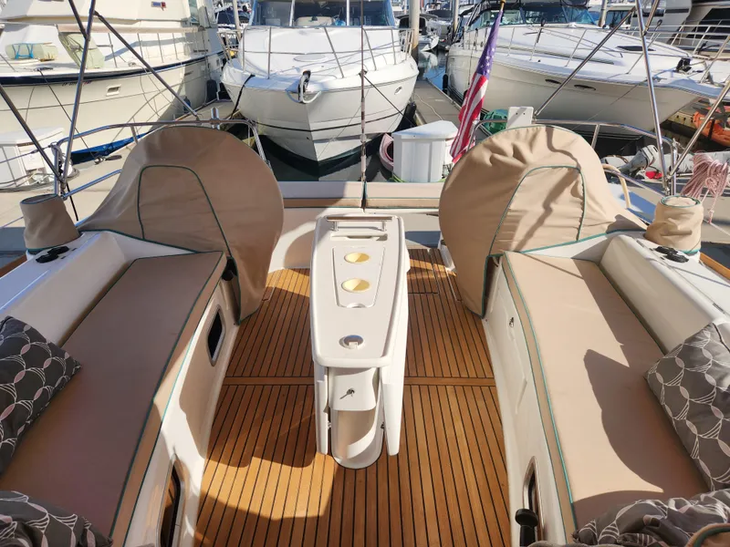 Slide: The Image of Beneteau Oceanis 50 cockpit, 2012 model, featuring teak flooring and cushioned seating. - 47