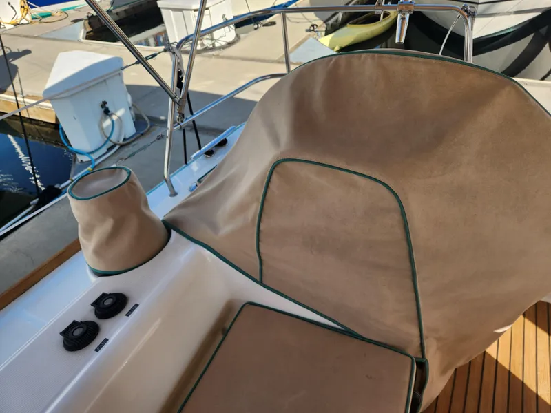 Slide: The Image of Beneteau Oceanis 50 cockpit with protective cover, 2012 model, docked at marina. - 49