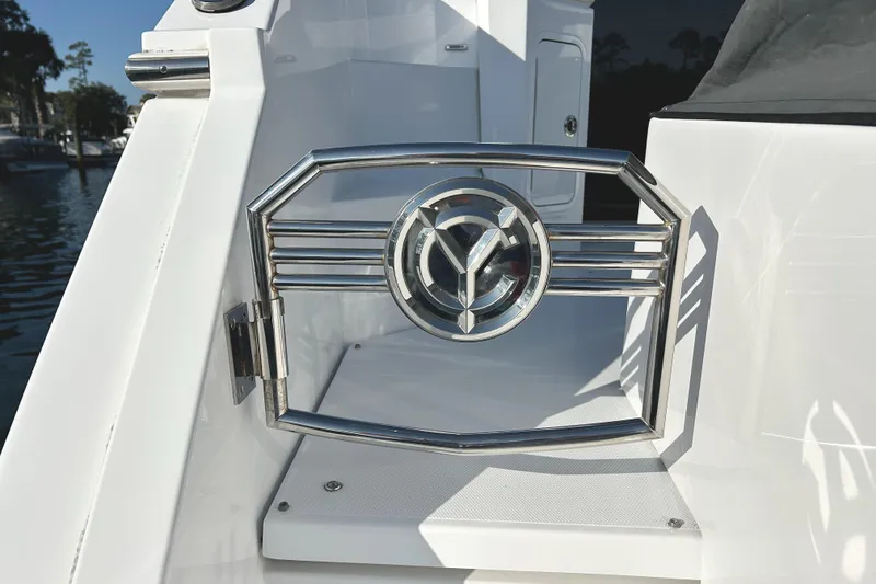 Slide: The Image of 2022 Cruisers Yachts 42 Cantius, chrome gate detail, docked by the water. - 10