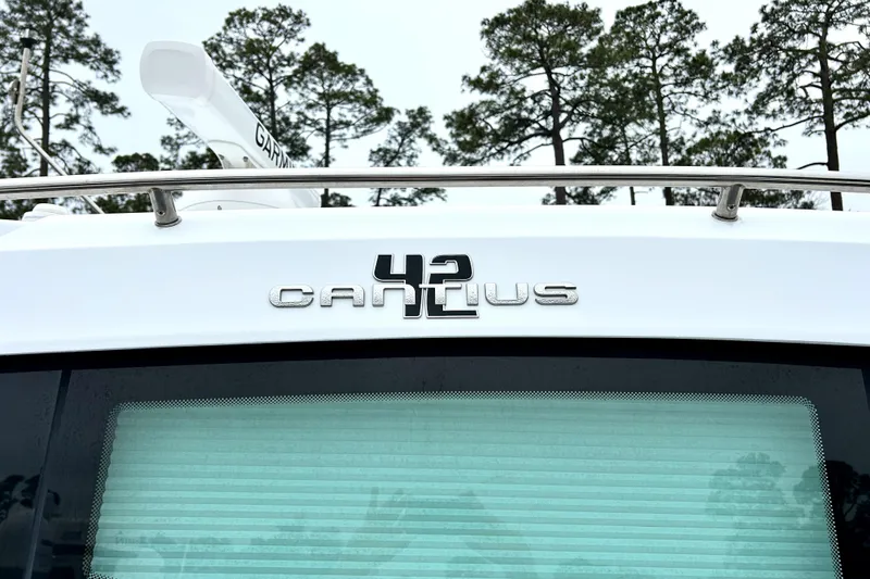 Slide: The Image of 2022 Cruisers Yachts 42 Cantius nameplate with trees in the background. - 11