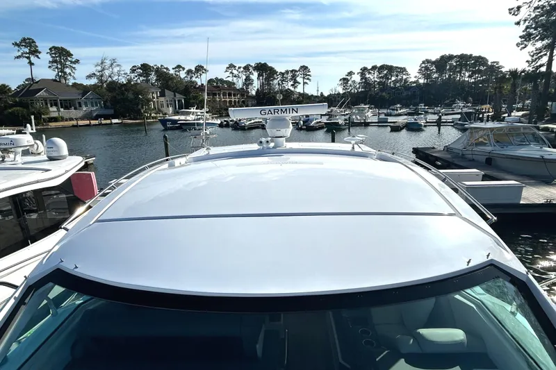Slide: The Image of 2022 Cruisers Yachts 42 Cantius docked at a marina with Garmin radar. - 12