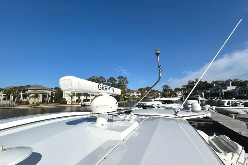 Slide: The Image of 2022 Cruisers Yachts 42 Cantius with Garmin equipment, docked under clear blue sky. - 13
