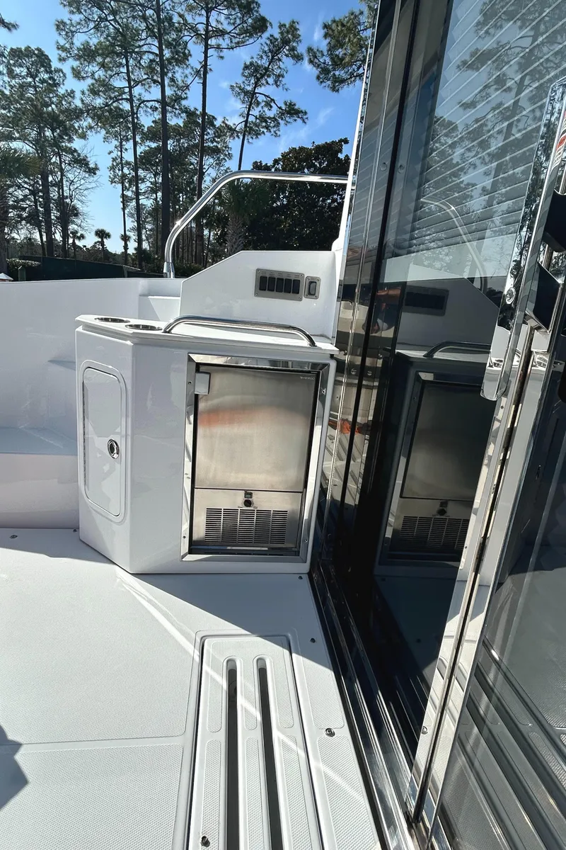 Slide: The Image of 2022 Cruisers Yachts 42 Cantius deck with outdoor kitchenette and sleek design. - 16