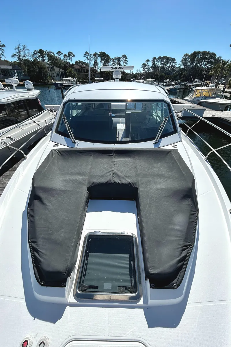 Slide: The Image of 2022 Cruisers Yachts 42 Cantius docked, showcasing sleek design and sunroof. - 17