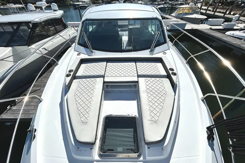Slide: The Image of 2022 Cruisers Yachts 42 Cantius with sleek deck design, docked at marina. - 18