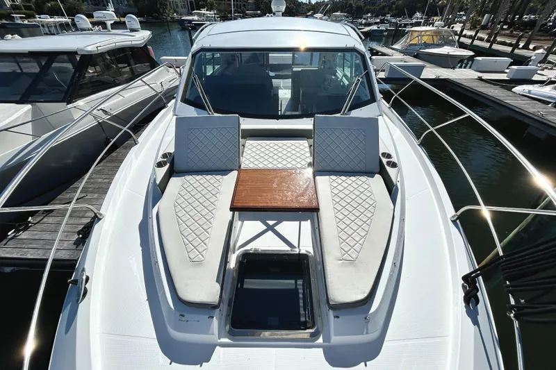 Slide: The Image of 2022 Cruisers Yachts 42 Cantius with sunbathing area and table on deck. - 19