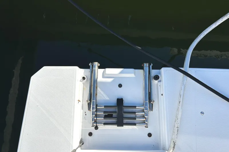 Slide: The Image of Swim platform ladder on 2022 Cruisers Yachts 42 Cantius, docked in water. - 22