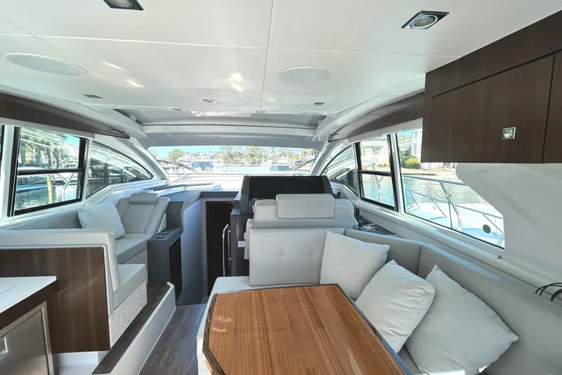 Slide: The Image of Interior of 2022 Cruisers Yachts 42 Cantius with modern seating and large windows. - 24