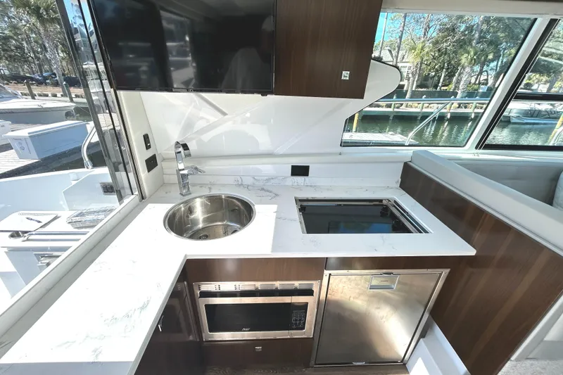 Slide: The Image of Modern kitchen in 2022 Cruisers Yachts 42 Cantius with sleek appliances and elegant design. - 27