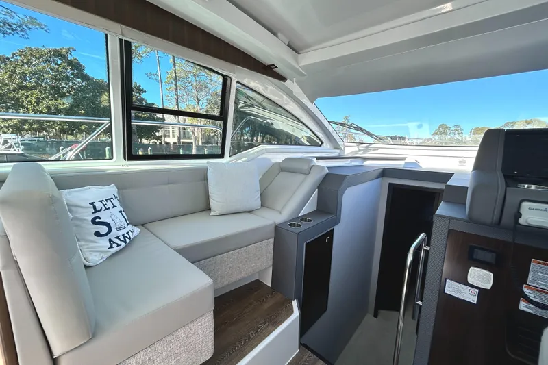 Slide: The Image of Luxurious interior of 2022 Cruisers Yachts 42 Cantius with plush seating and scenic windows. - 29