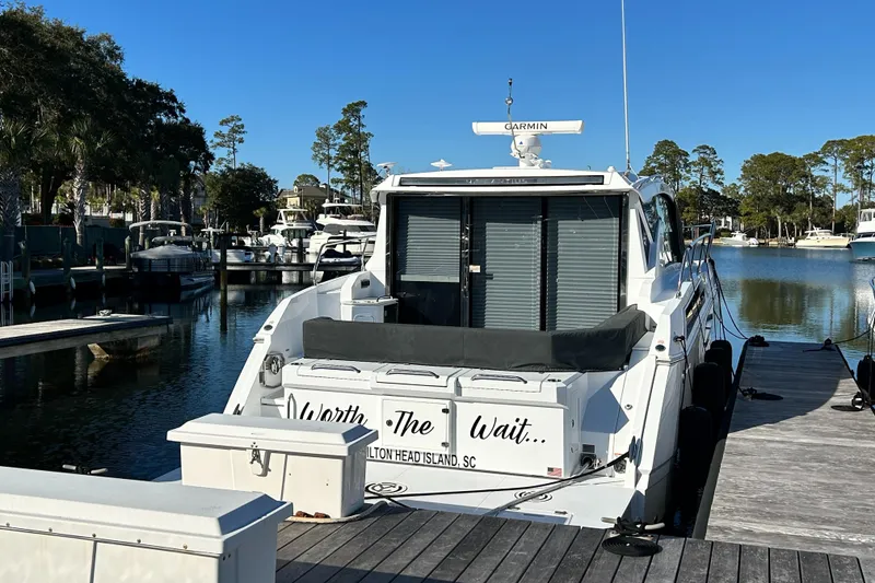 Slide: The Image of 2022 Cruisers Yachts 42 Cantius docked at a marina, rear view. - 3