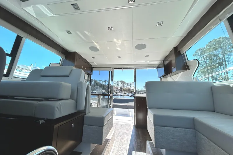 Slide: The Image of Interior of 2022 Cruisers Yachts 42 Cantius with modern seating and large windows. - 32