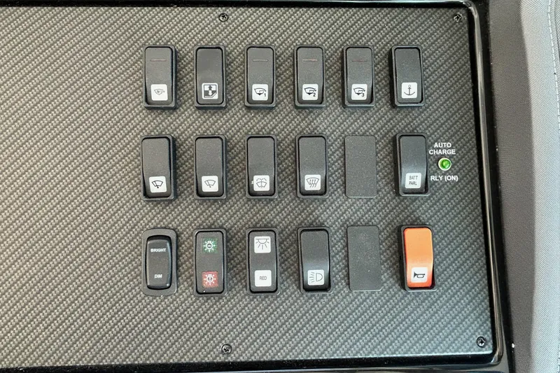 Slide: The Image of Control panel of 2022 Cruisers Yachts 42 Cantius with various switches and indicators. - 38