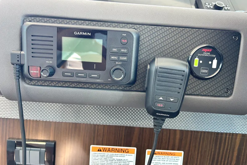 Slide: The Image of Control panel of 2022 Cruisers Yachts 42 Cantius with Garmin marine radio and warning labels. - 39