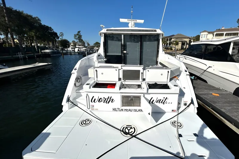 Slide: The Image of 2022 Cruisers Yachts 42 Cantius docked, rear view with "Worth the Wait" text. - 4