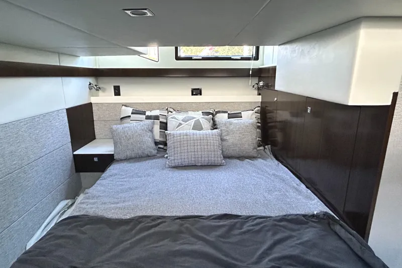 Slide: The Image of Luxurious bedroom interior of 2022 Cruisers Yachts 42 Cantius with modern bedding and sleek design. - 43