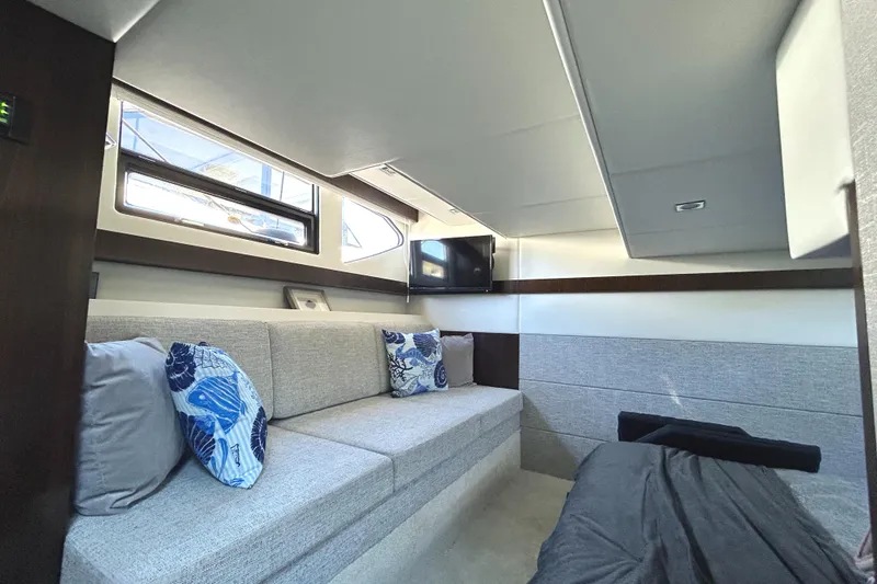 Slide: The Image of Interior of 2022 Cruisers Yachts 42 Cantius with modern seating and decorative pillows. - 44