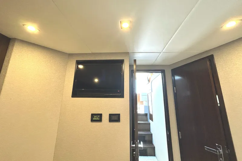 Slide: The Image of Interior of 2022 Cruisers Yachts 42 Cantius, featuring modern lighting and a wall-mounted TV. - 47