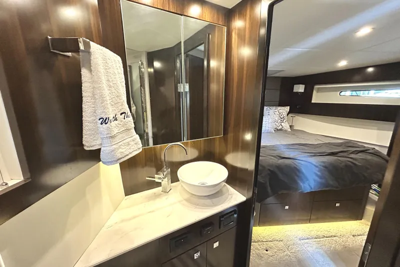 Slide: The Image of Luxurious interior of 2022 Cruisers Yachts 42 Cantius with modern bathroom and cozy bedroom. - 48