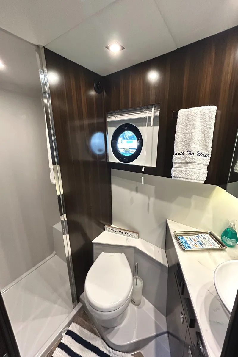 Slide: The Image of Luxurious 2022 Cruisers Yachts 42 Cantius bathroom with modern fixtures and elegant wood accents. - 49