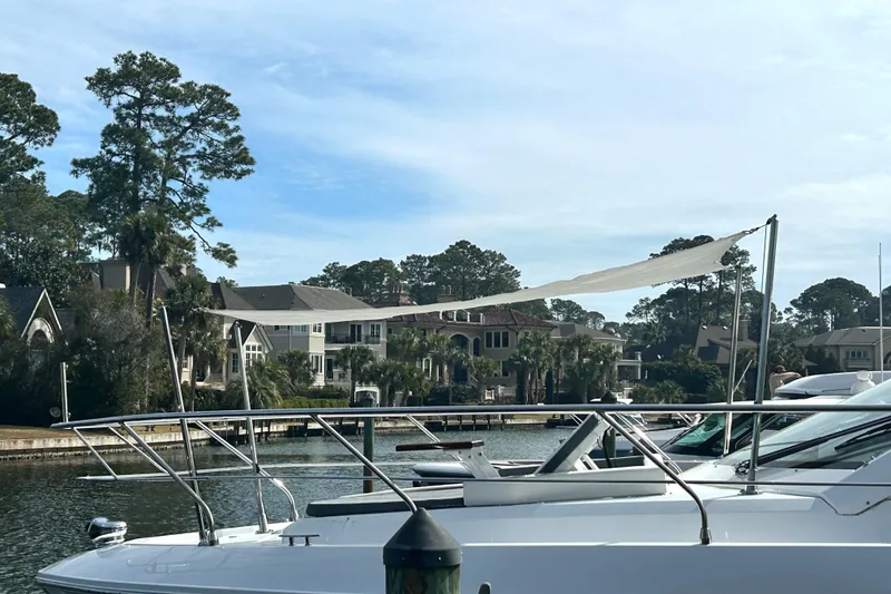 Slide: The Image of 2022 Cruisers Yachts 42 Cantius docked near waterfront homes. - 6