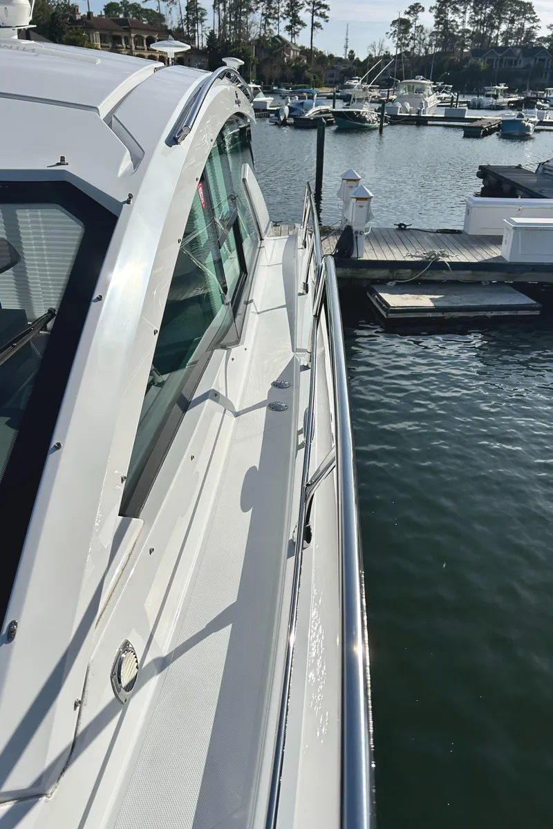 Slide: The Image of 2022 Cruisers Yachts 42 Cantius docked at a marina, side view. - 9