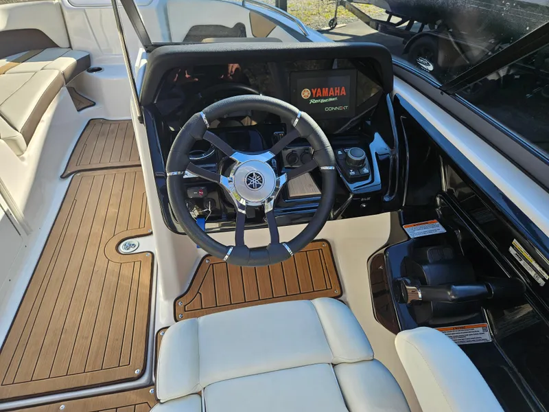 Slide: The Image of 2022 Yamaha Boats 212S cockpit with steering wheel and dashboard controls. - 13