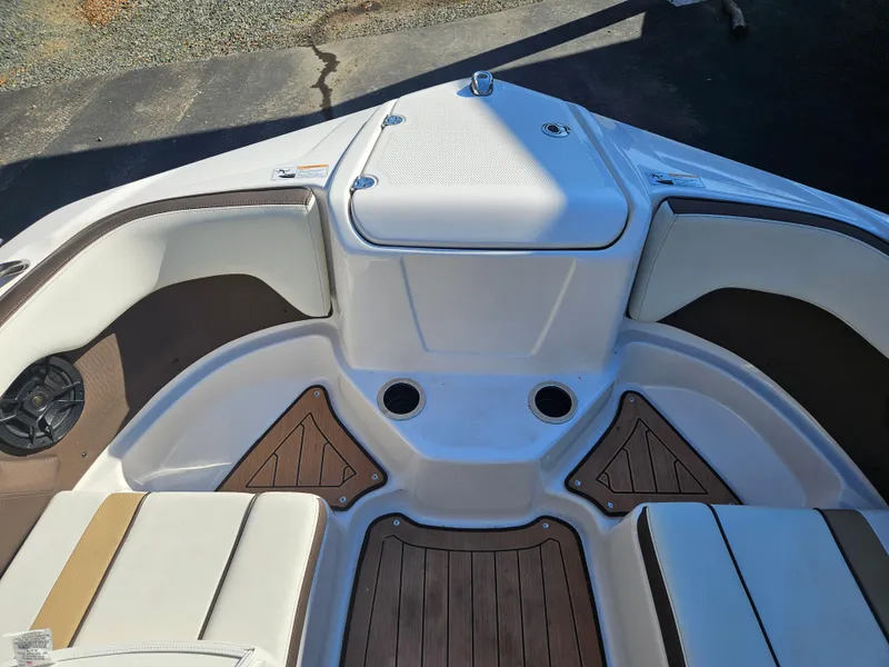 Slide: The Image of 2022 Yamaha Boats 212S interior, featuring sleek seating and wood accents. - 14