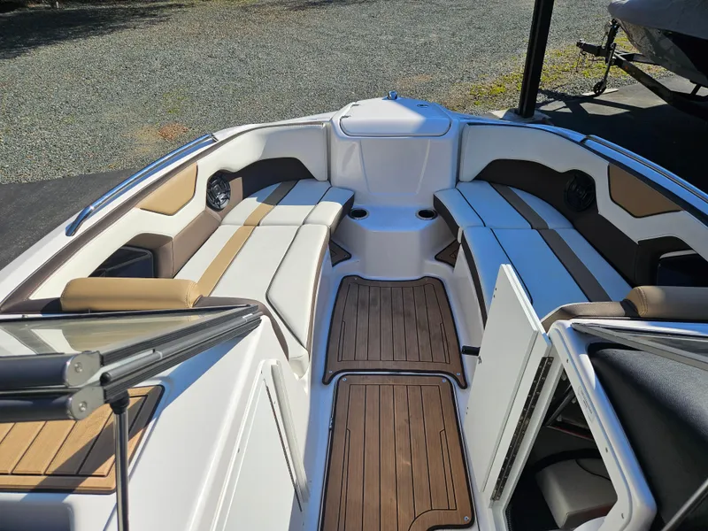 Slide: The Image of 2022 Yamaha Boats 212S interior with sleek seating and wood accents. - 15