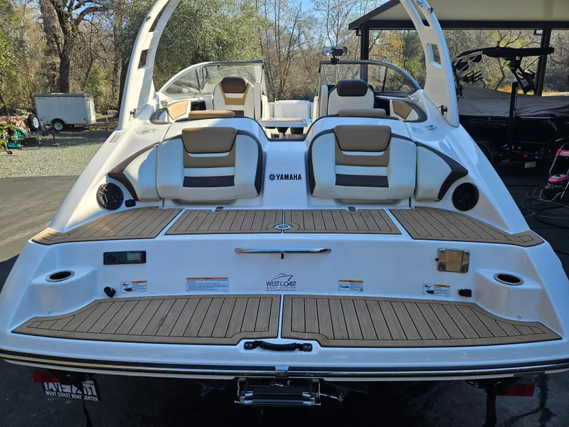 Slide: The Image of 2022 Yamaha Boats 212S, rear view, showcasing spacious deck and seating area. - 17