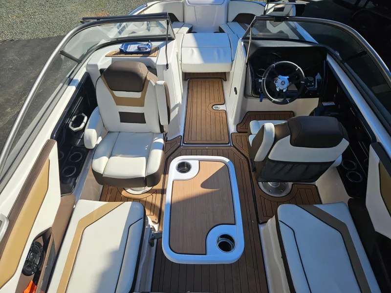 Slide: The Image of 2022 Yamaha Boats 212S interior with sleek seating and modern dashboard design. - 19