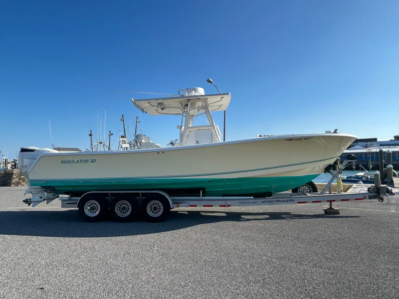 Slide: The Image of 2000 Regulator 32 Classic boat on trailer under clear blue sky. - 0