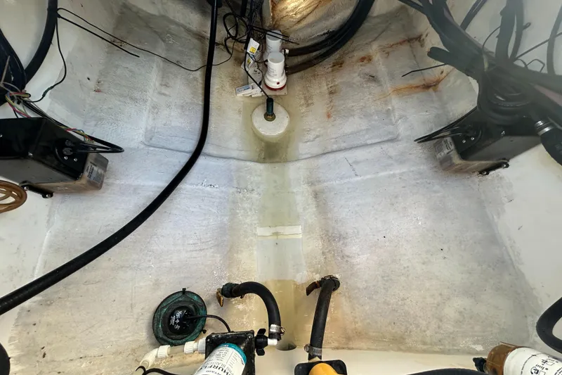 Slide: The Image of Bilge area of a 2000 Regulator 32 Classic boat, showing pumps and wiring. - 10