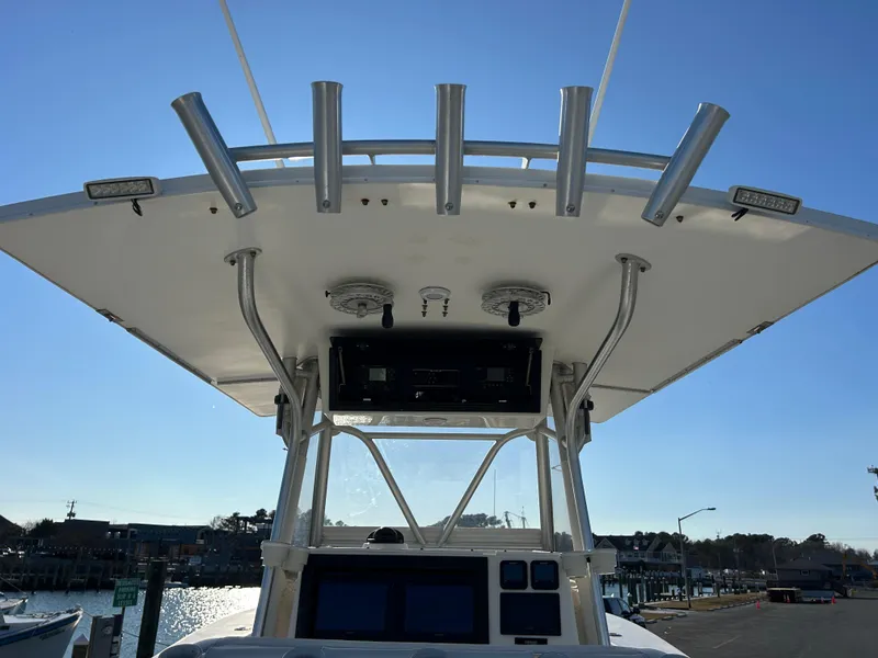 Slide: The Image of Regulator 32 Classic 2000 boat with T-top and rod holders, docked at marina. - 17