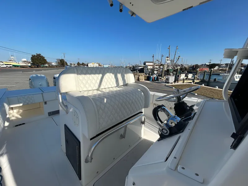 Slide: The Image of 2000 Regulator 32 Classic boat interior with helm and seating, docked at marina. - 18