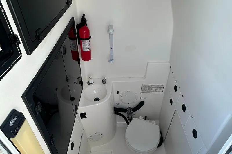 Slide: The Image of Compact bathroom in a 2000 Regulator 32 Classic boat with sink and toilet. - 19