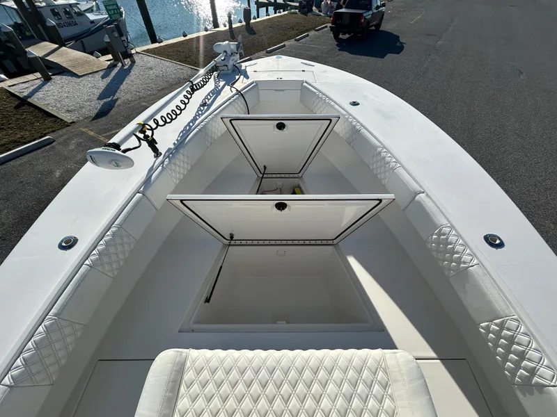 Slide: The Image of 2000 Regulator 32 Classic boat with open storage compartments, docked at marina. - 21