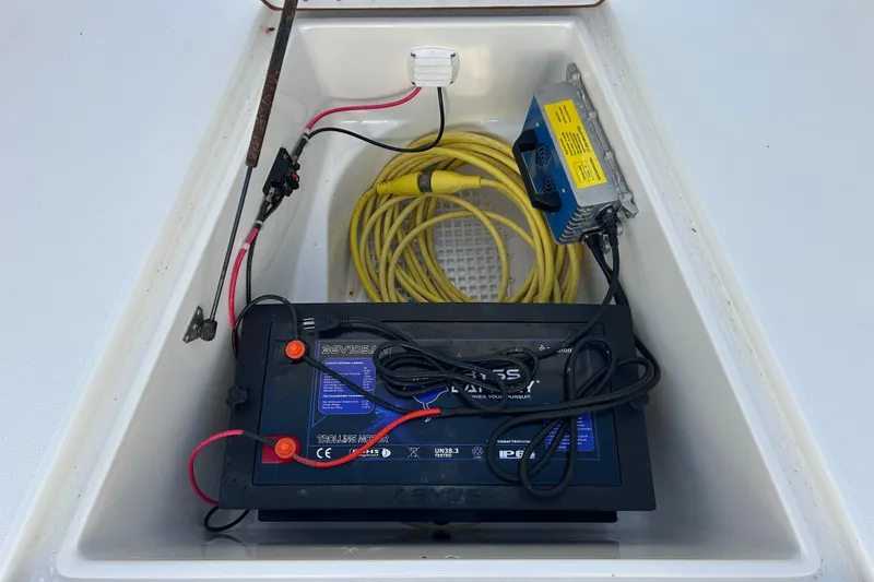 Slide: The Image of Battery compartment of 2000 Regulator 32 Classic boat with cables and charger. - 22