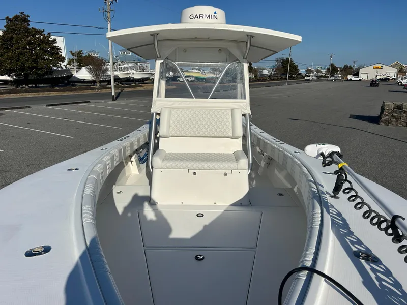 Slide: The Image of 2000 Regulator 32 Classic boat with Garmin equipment, docked in a parking area. - 24