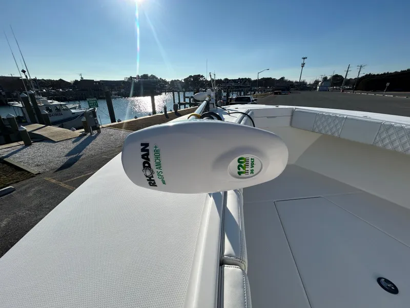 Slide: The Image of 2000 Regulator 32 Classic boat with Minn Kota trolling motor at a marina. - 25